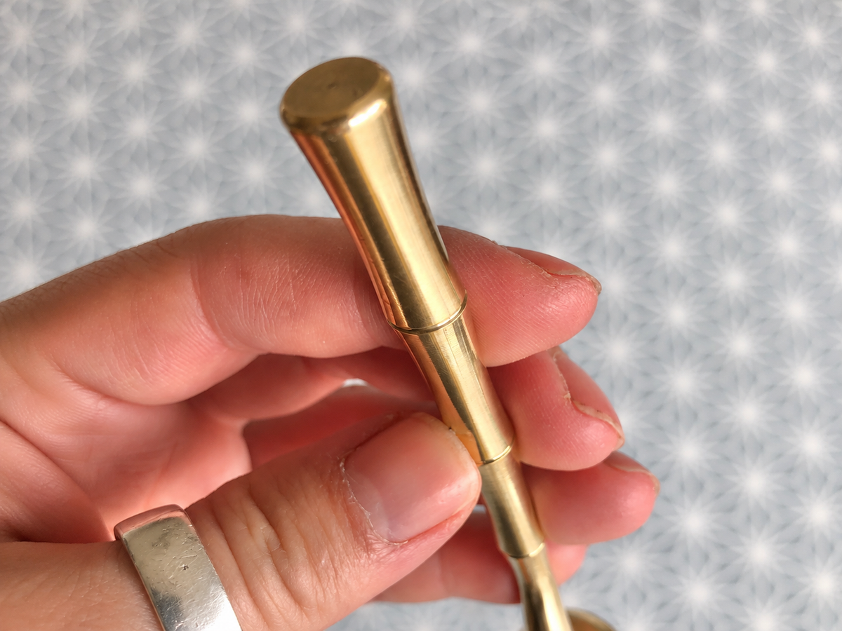 Bamboo-effect handle detail on solid brass terrarium soil scoop