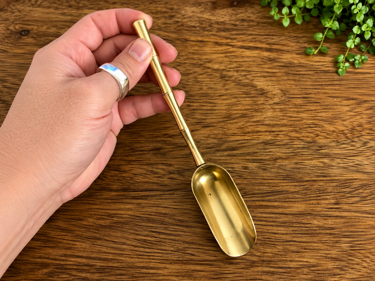 Mini brass soil scoop with gold bamboo-effect handle for terrariums